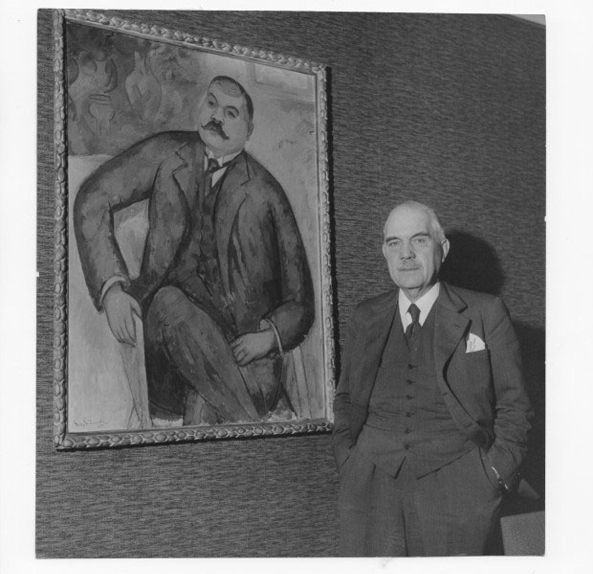 Axel F Enström standing in front of a portrait of himself