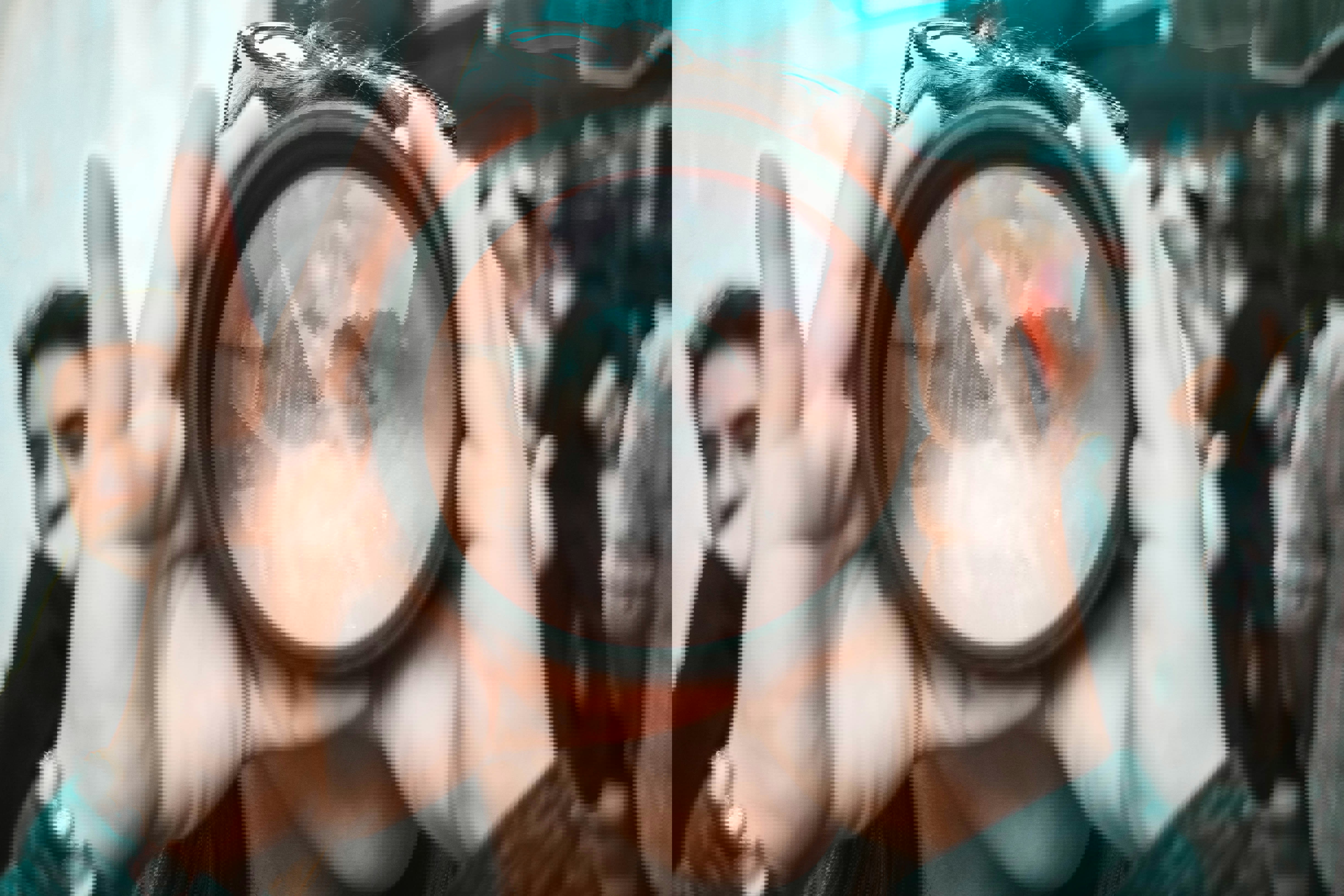 person holding lens in front of face