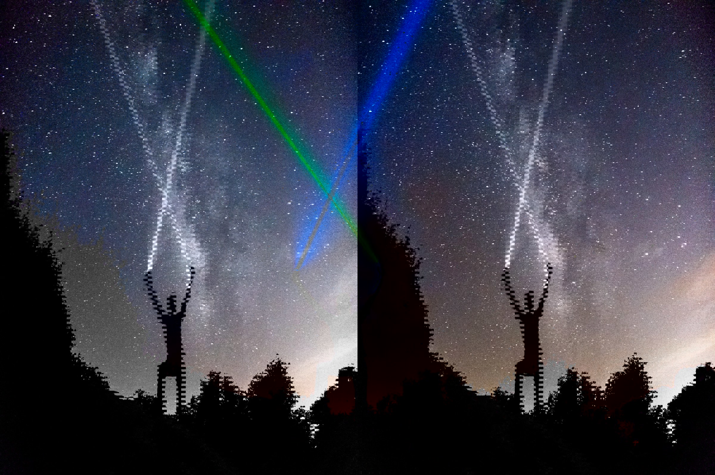 Person Crossing Laser Beams Into Sky