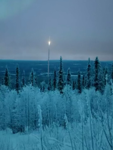 Satellite shooting up from a wintry forest landscape 