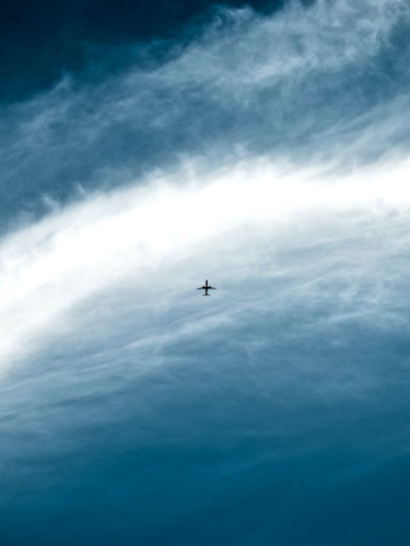 clouds in the sky and small airplane
